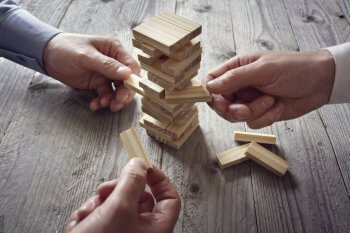 Berufswelt im Management Hände, die Jenga spielen